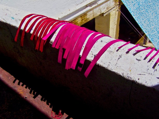 Fez Morocco Newly dyed leather hangs from a railing in Fez, Morocco.