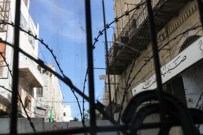 A fence separates Israel settlers from Palestinians